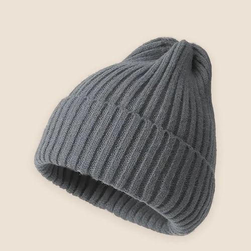 Unisex crochet knit beanie on a warm neutral background