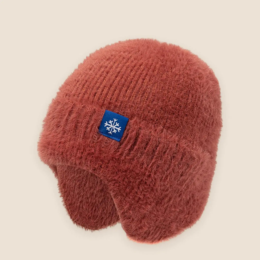 Women's faux fur earflap beanie on a warm neutral background