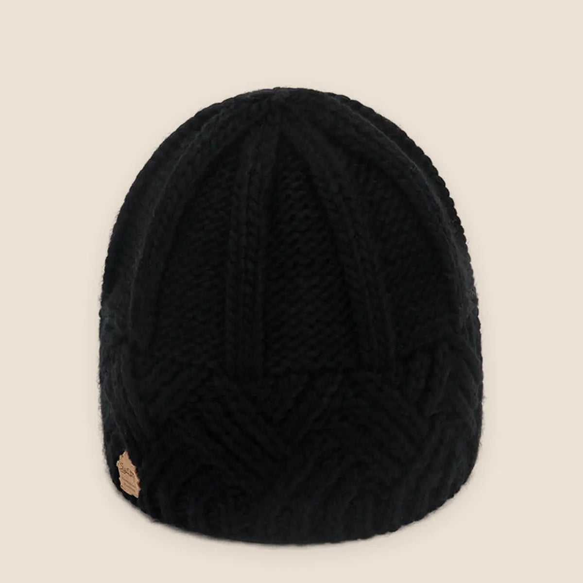 Unisex ribbed knit beanie on a warm neutral background