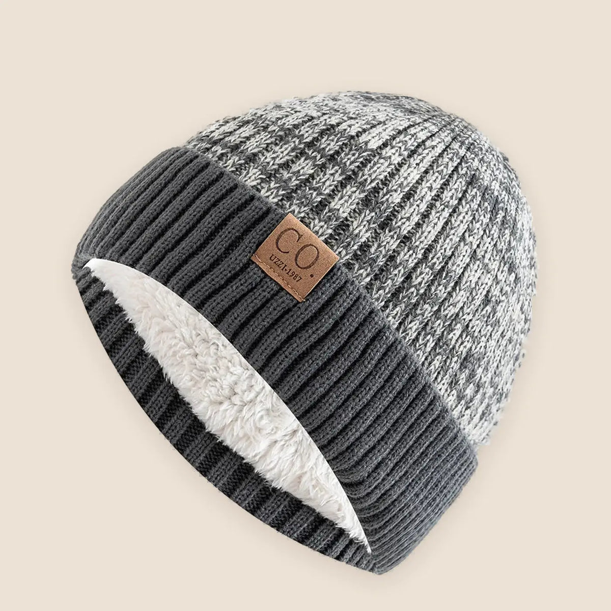 Unisex two tone fur lined beanie on a warm neutral background