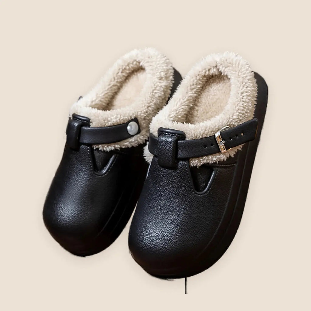 Women's faux fur mule slippers on a warm neutral background